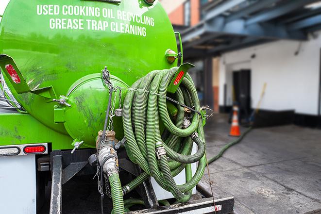 a professional technician pumping a restaurant's grease trap in Genesee ID